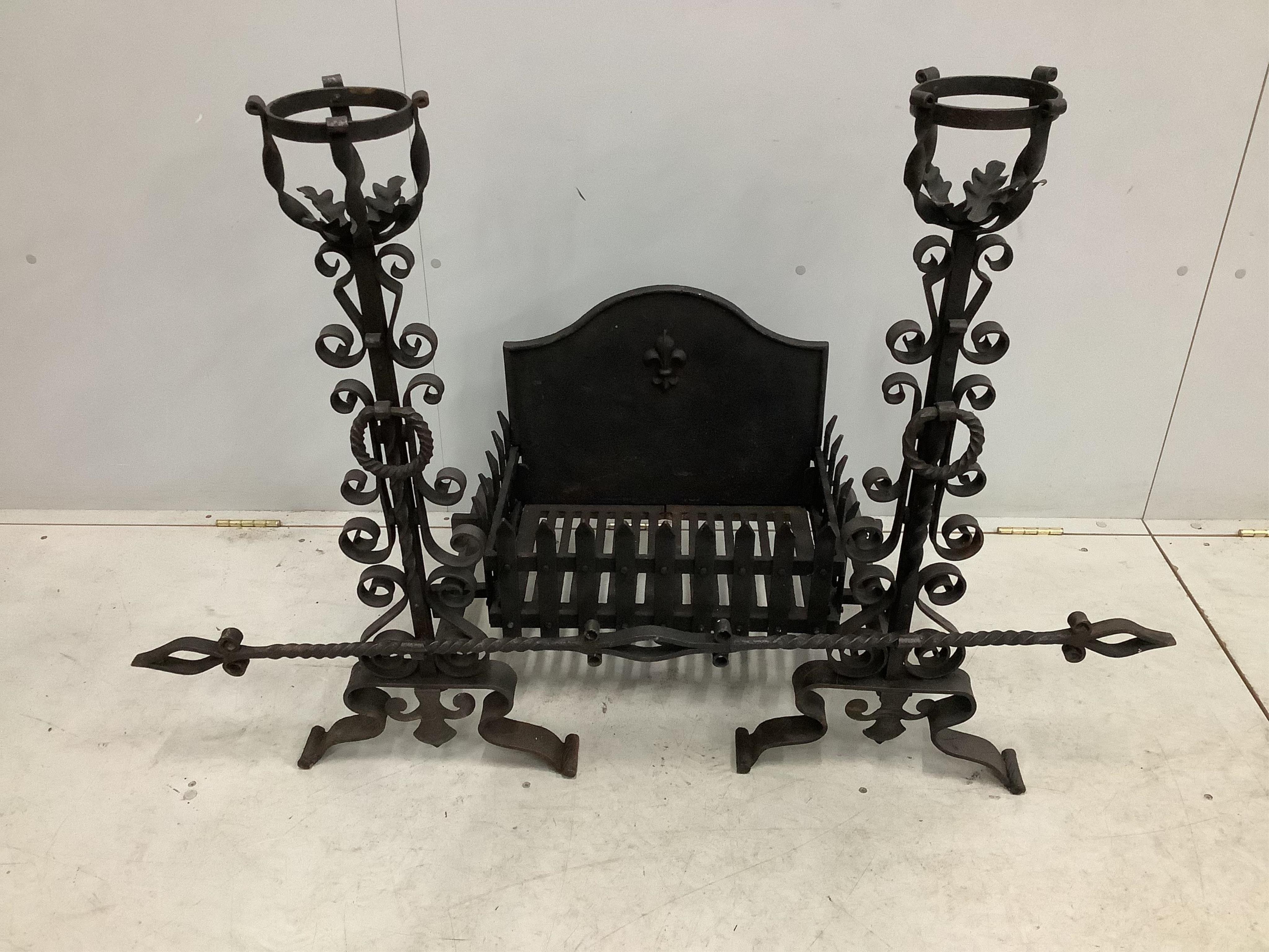 A French wrought iron fire basket with dogs and cast fire back, width 127cm, depth 53cm, height 88cm. Condition - good